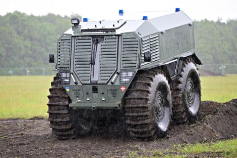 A person sitting in a military vehicle outdoors